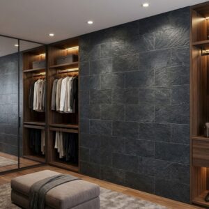 dormitorio interior con estilo moderno, pared de piedra gris oscura como revestimiento, suelo de madera, armarios empotrados de madera oscura con ropa y zapatos, banco de cuero gris.