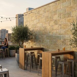 Terraza exterior con revestimiento pared exterior Fuji Ocre efecto piedra. Mesas y personas.