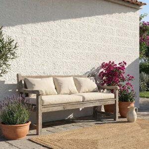 Revestimiento pared exterior efecto piedra marfil en una terraza con banco y plantas.